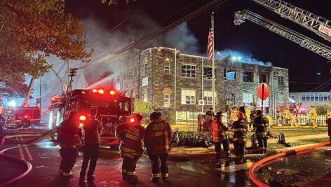 Fire fighters putting out building fire.