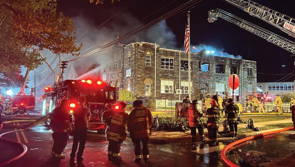 Fire fighters putting out building fire.