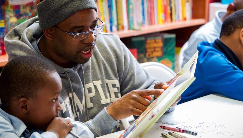 Man reading to a young boy at Treehouse Books.