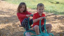 A boy and girl enjoy new playground equipment at Whitemarsh's Magical Miles Park in Lafayette Hill.