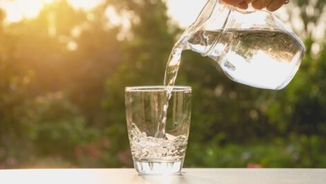 Fresh water being poured into a pitcher.