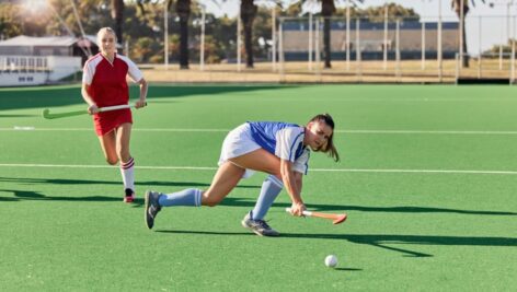 Two field hockey players on the field.