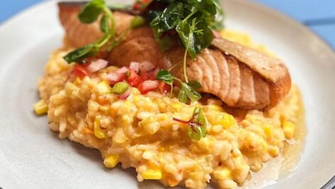 Atlantic salmon with risotto and pico de gallo and cilantro.