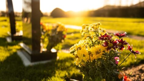 Grave marker and flowers in a cemetery.