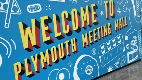 A colorful sign that reads 'Welcome to the Plymouth Meeting Mall.'