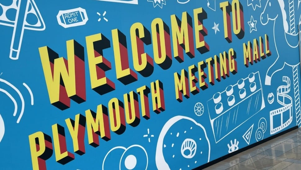 A colorful sign that reads 'Welcome to the Plymouth Meeting Mall.'