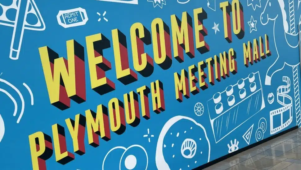A colorful sign that reads 'Welcome to the Plymouth Meeting Mall.'