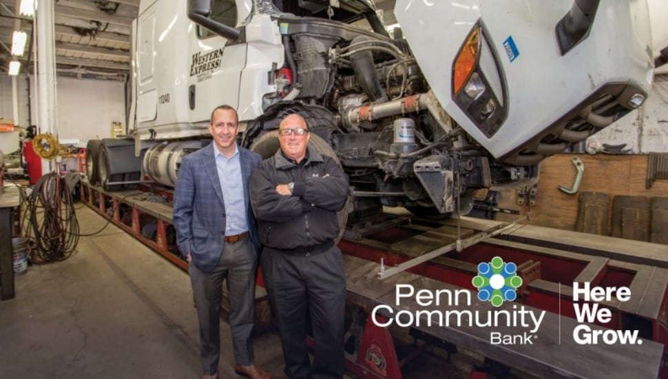 Rob Leipziger in his shop, posing with Penn Community Bank commercial lender Tony Santoro, in front of a lifted truck.