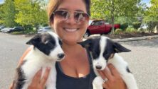 Director Angie Lafond holding to rescued puppies.