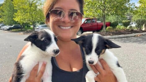 Director Angie Lafond holding to rescued puppies.