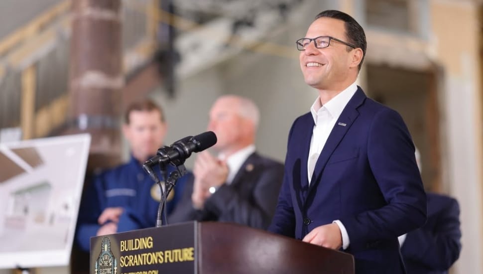 Governor Josh Shapiro addressing a crowd from a podium.