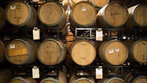 Racks of beer barrels stacked on top of one another.