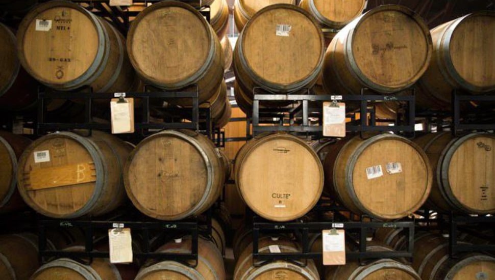 Racks of beer barrels stacked on top of one another.