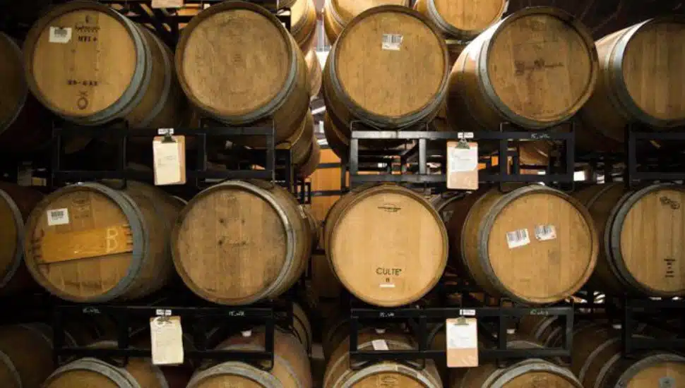 Racks of beer barrels stacked on top of one another.
