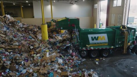 Waste Management truck inside facility.