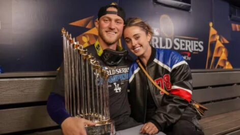 Erin Matson sitting with boyfriend Ben Casparius with World Series trophy.