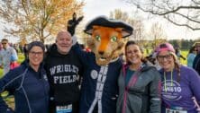 Runners of the Rev Run huddled together with the Rev Run mascot.