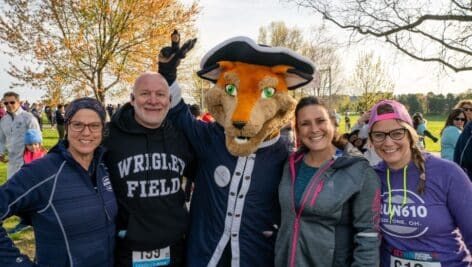 Runners of the Rev Run huddled together with the Rev Run mascot.