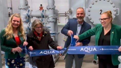 Officials from Aqua cutting the ceremonial ribbon at new PFAS treatment system.