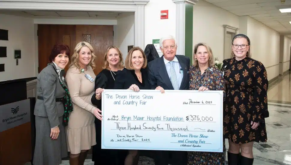 Officials from the Devon Horse Show presenting a 5,000 check to the Bryn Mawr Hospital.