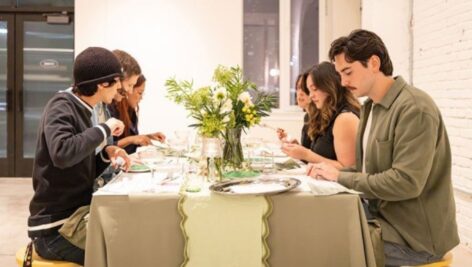 Four people sitting for dinner in a restaurant.