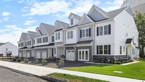 Outfront of a group of townhomes by Foxlane Homes.