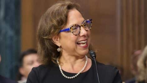 Gail Weilheimer smiling while in court.