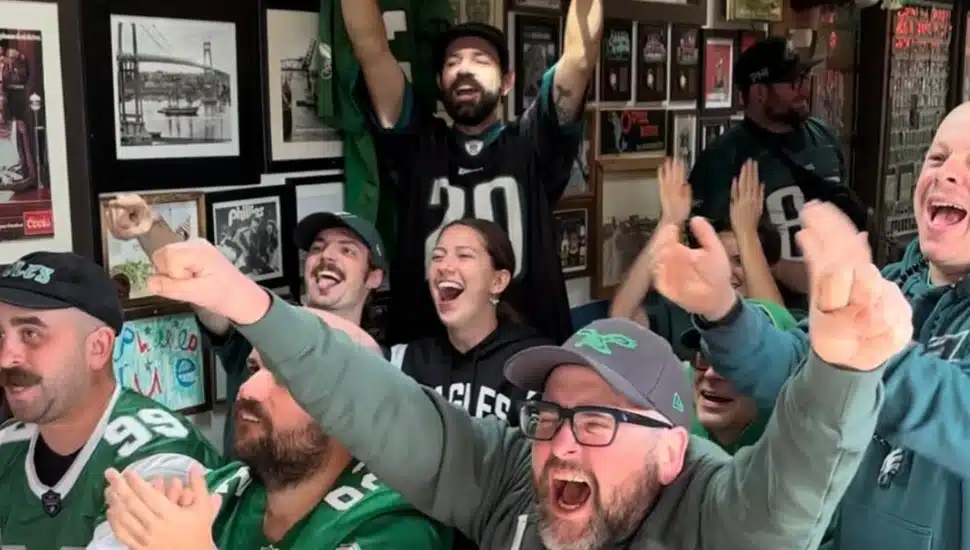 Eagles fans cheering as they watch the game at Lombard House.