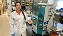 Sihem Nadour standing in a biotech lab at Montgomery County Community College.