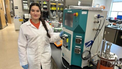 Sihem Nadour standing in a biotech lab at Montgomery County Community College.