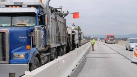 A truck waving an orange flag on the PA Turnpike.