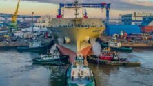 A large boat docked at the Philly Shipyard.