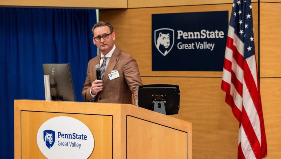Professor and Chancellor Colin J. Neill speaks at a podium at Penn State Great Valley.