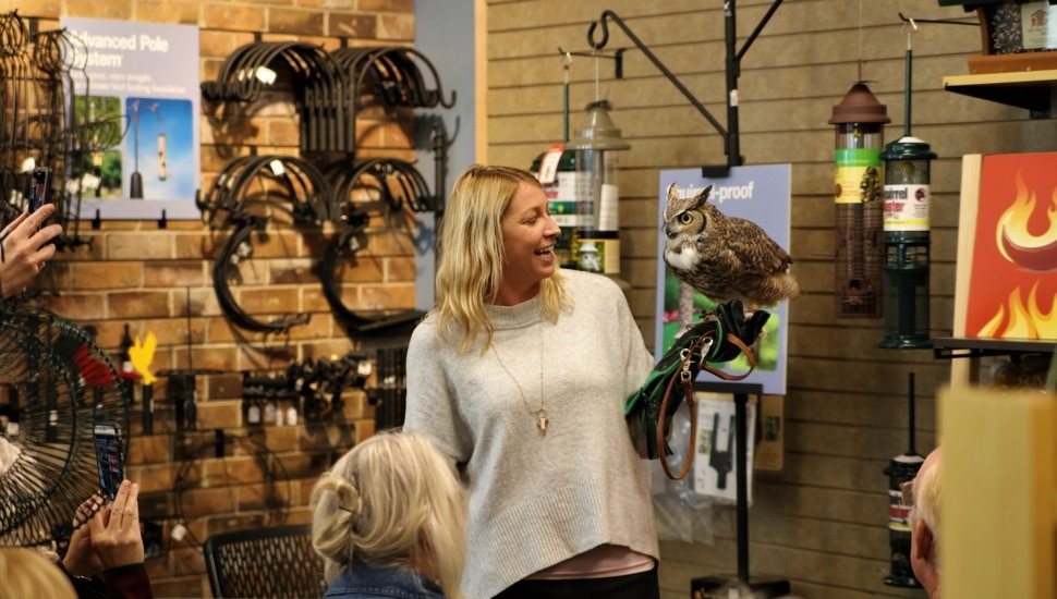 A volunteer holding an owl at the John James Audubon Center.