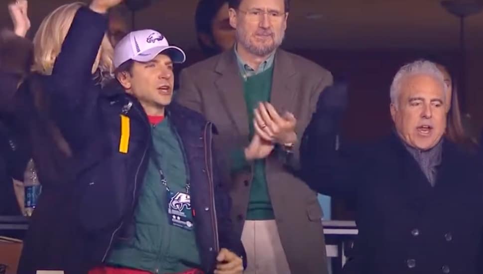 Bradley Cooper cheering the Eagles in the luxury box with team owner Jeffrey Lurie.