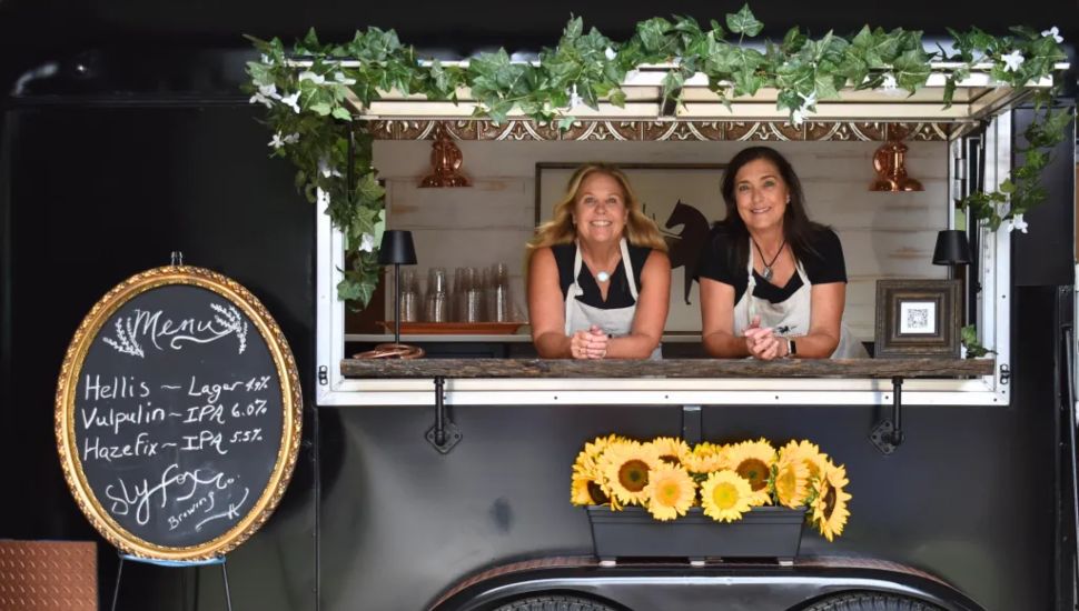Copper Pony owners Joann Fisher and Carolyn Dunkel in their mobile bar.