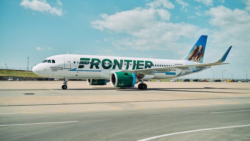 A Frontier Airlines aircraft sitting at the airport.