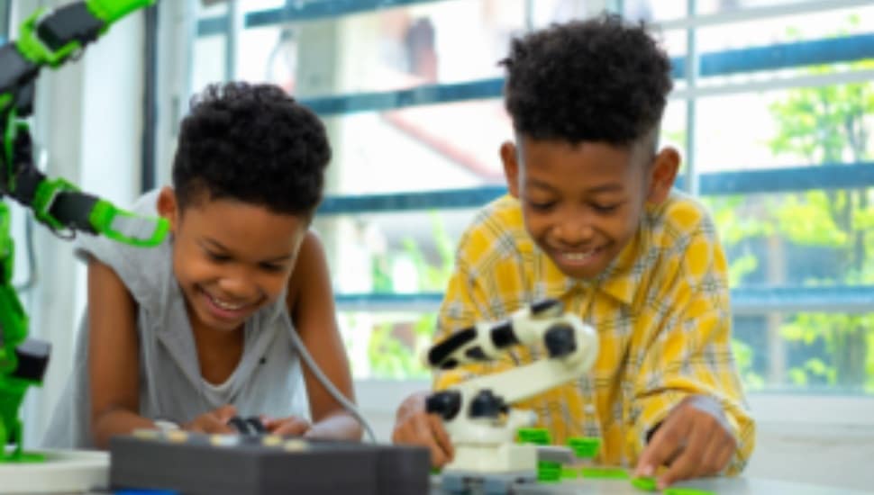 Two boys work on a hand-on project.