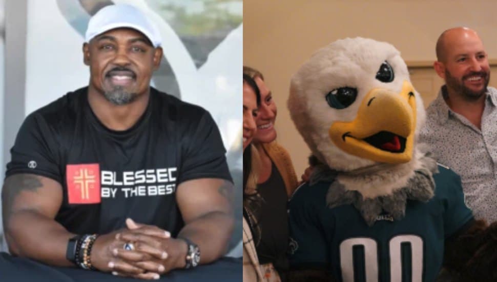 On left: Football Hall of Famer and Eagles Legend, Brian Dawkins; on right, Swoop posing for a picture with a group.