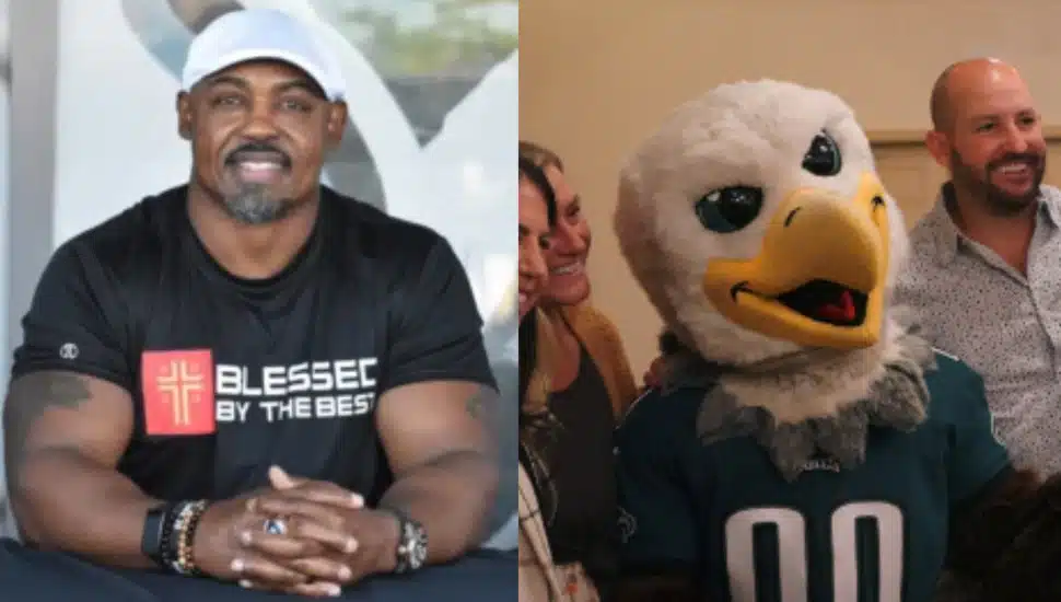 On left: Football Hall of Famer and Eagles Legend, Brian Dawkins; on right, Swoop posing for a picture with a group.