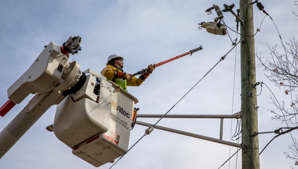 Utility worker fixes a power line.