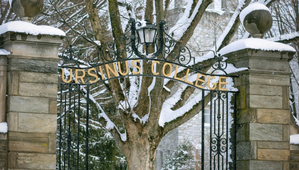 Outdoor sign at Ursinus College covered in snow.