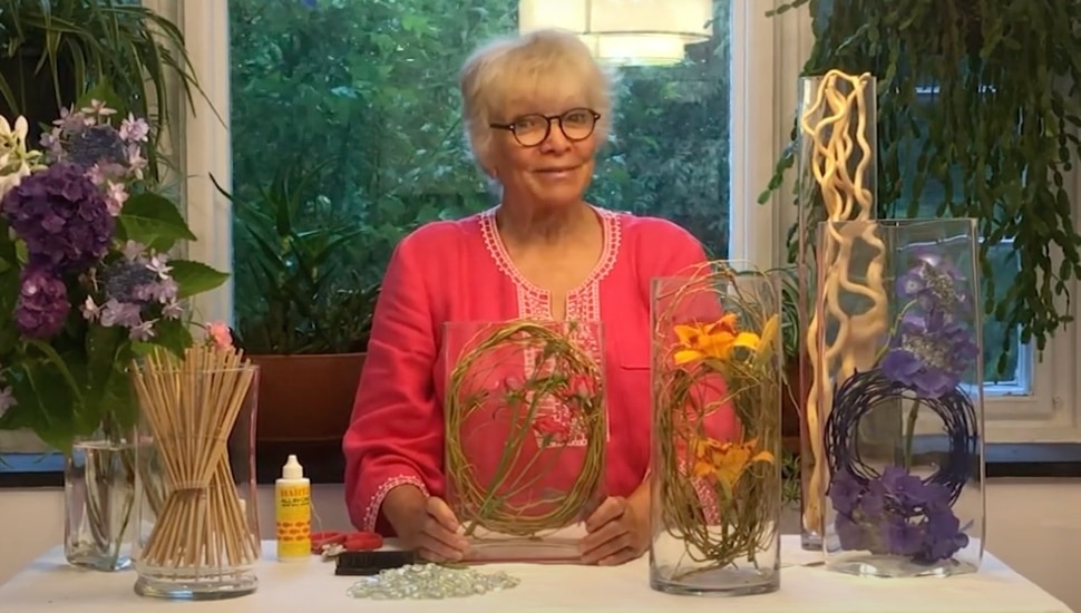 Wilfreta Baugh standing by a table with items for a garden display.