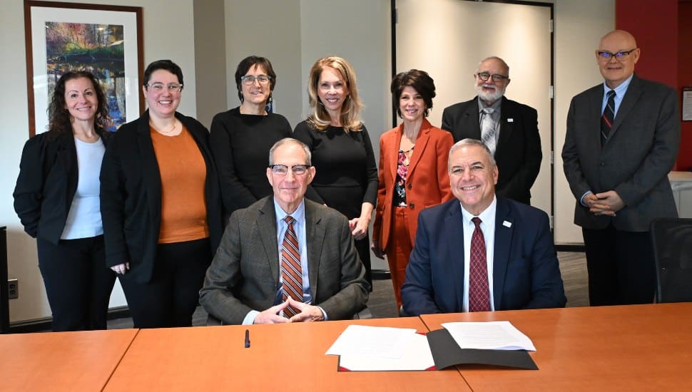 A group picture of individuals gathered at a table, indicating the new partnership between Salus at Drexel University and Bestwork Industries.