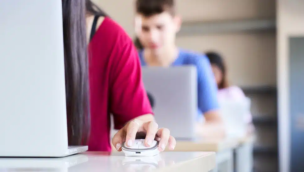 Students on computers in a classroom.