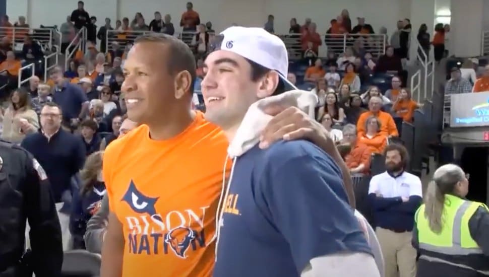 Alex Rodriguez smiles with Owne Garwood after sinking a half-court shot.