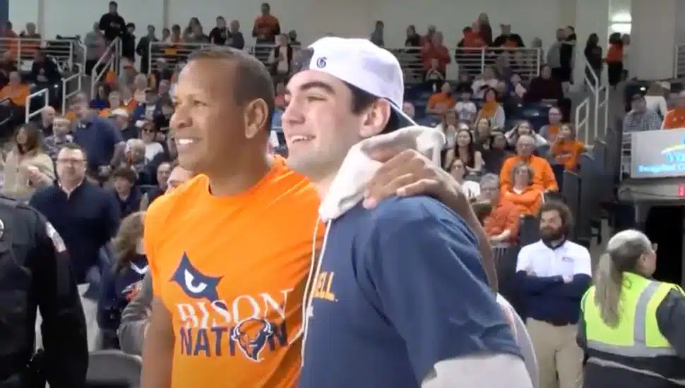 Alex Rodriguez smiles with Owne Garwood after sinking a half-court shot.