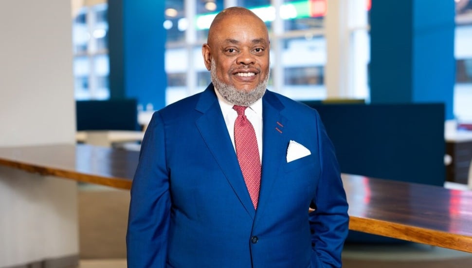 Healthcare executive in blue suit and red tie.