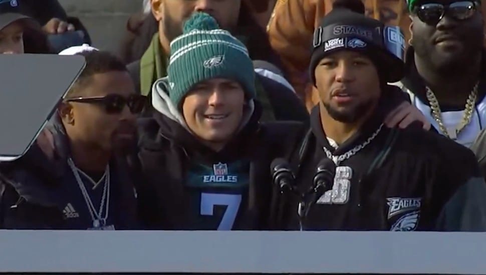Ryan Quigley stands with Eagles players at the Super Bowl parade.
