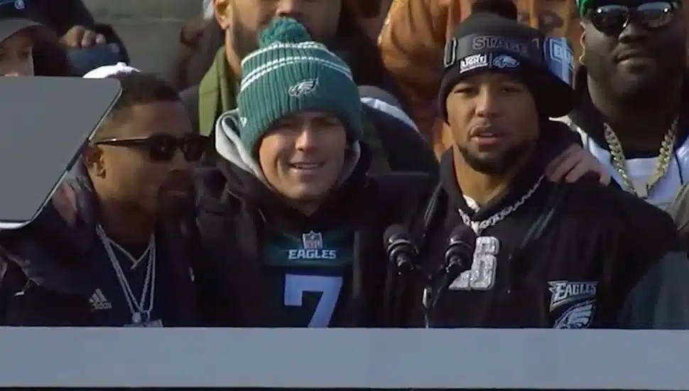 Ryan Quigley stands with Eagles players at the Super Bowl parade.